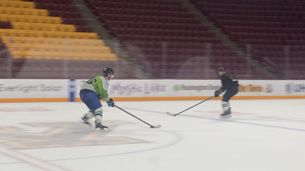 Adult hockey league players in action during a St. Paul game